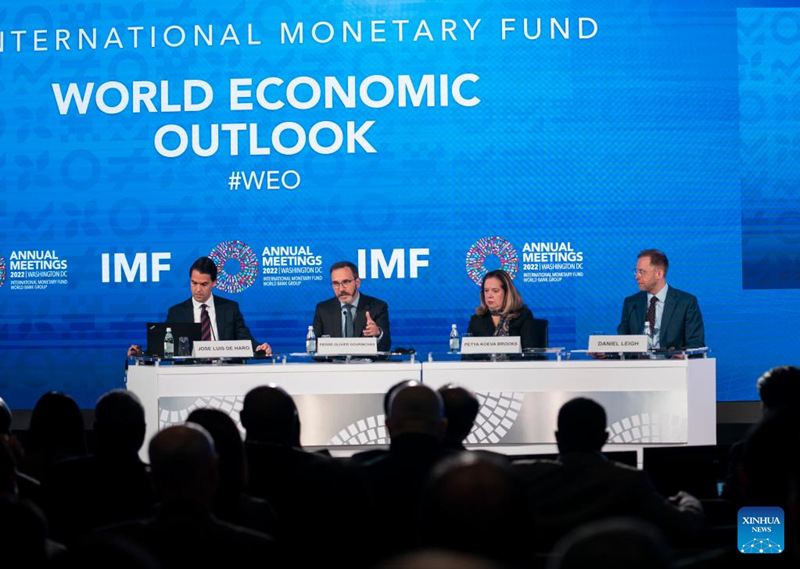 IMF chief economist Pierre-Olivier Gourinchas (2nd L) speaks at a press conference in Washington, D.C., the United States, on Oct. 11, 2022.